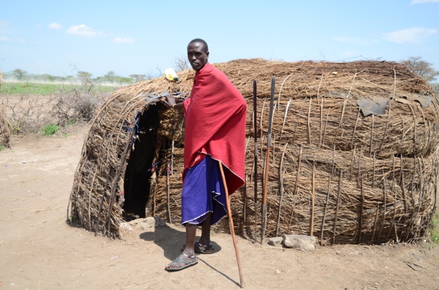 A Masai tribesman in front of his house.
